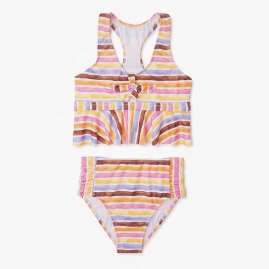 Girls multicolor watercolor stripe racerback tankini with bow-tie cutout and ruffle hem, both pieces on clean white background